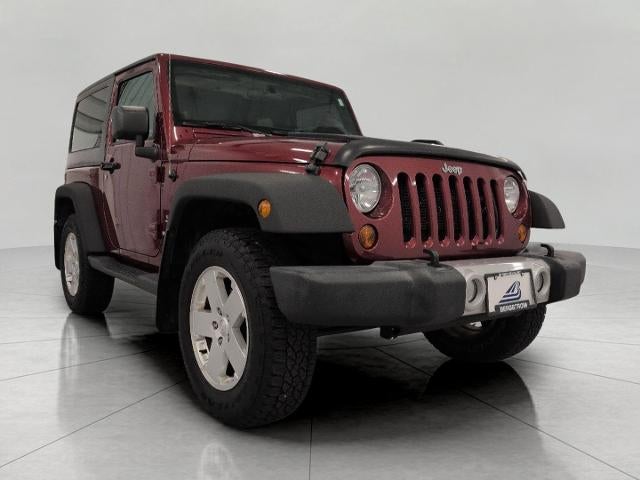 2012 Jeep Wrangler Sahara in Red — front three-quarter view
